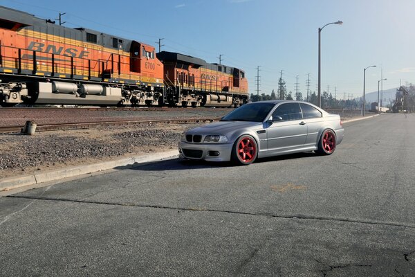 Silver BMW by the railway