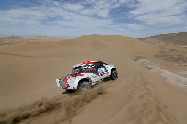 Toyota Dakar car on the background of sand