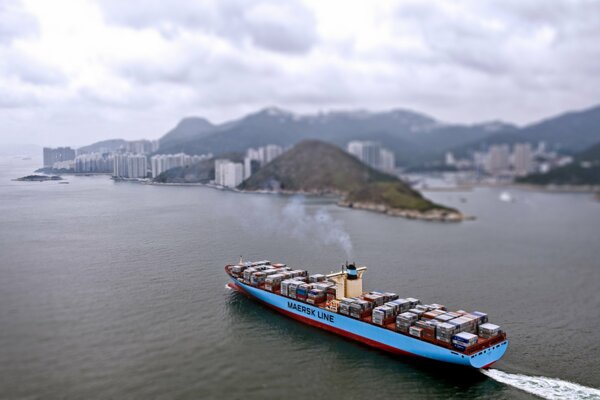 Cargo container ship on the move goes to the port