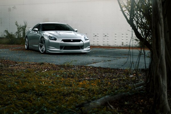 Silver Nissan on a dark road