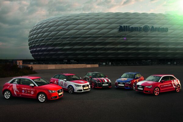 Five racing Audis near the stadium