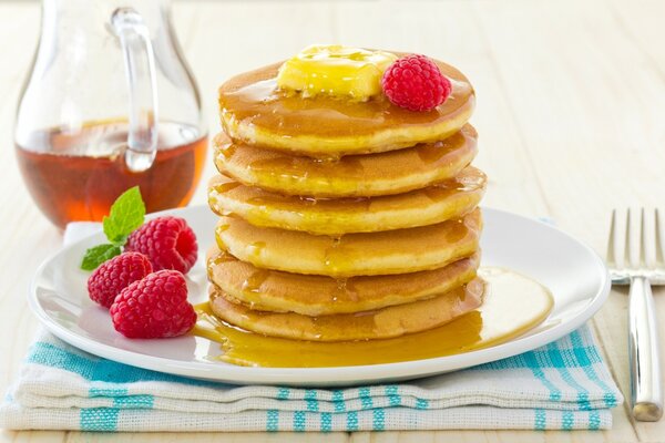 Pancakes with honey, decorated with raspberries