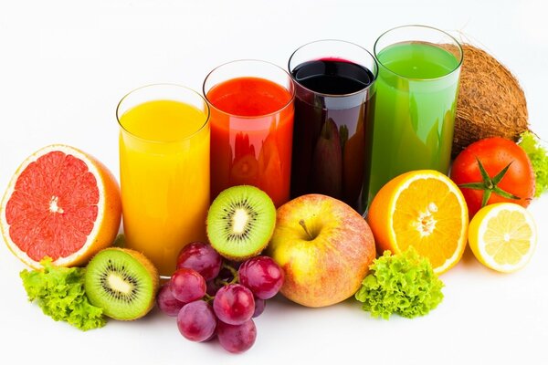 Glasses with juice and fruit around