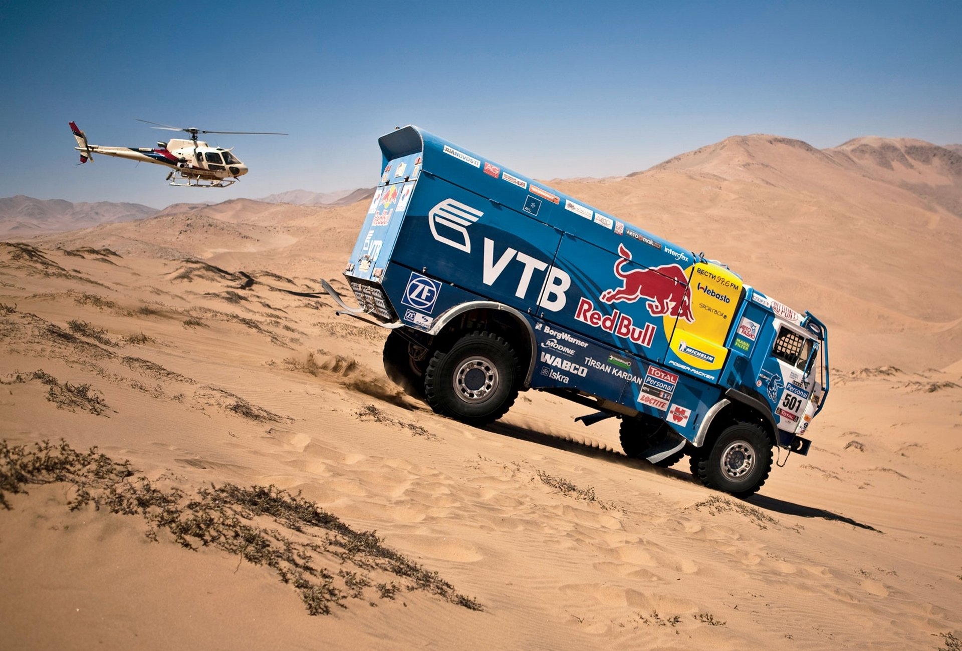 kamaz dakar rally blue red bull helicopter side view descent car auto sand dune