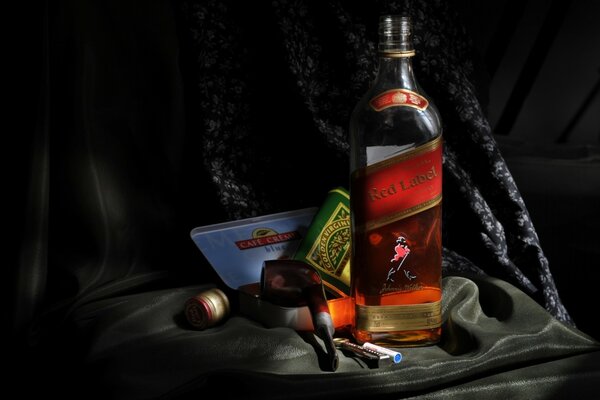 Whiskey and cigars on a black background