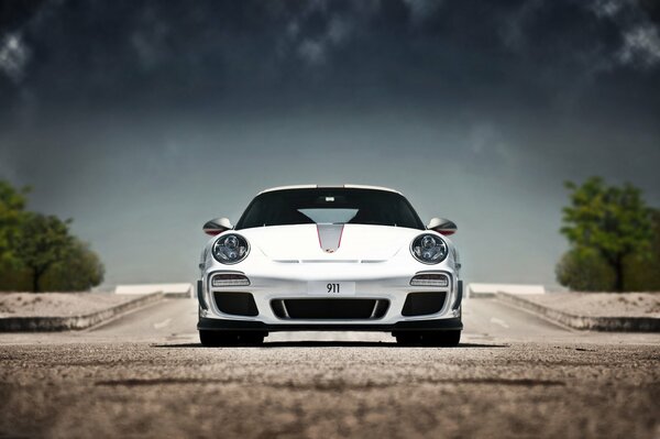 White Porsche under the open sky, front view