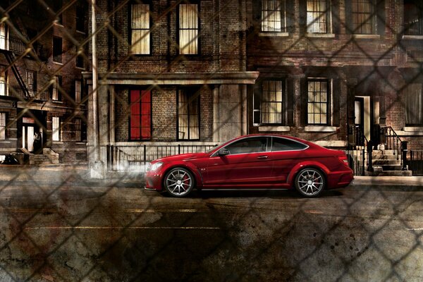 Red car on the background of a building