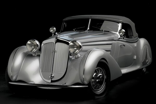 Vintage silver car on a black background