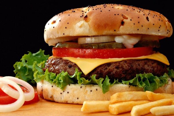 Large hamburger with potatoes and vegetables