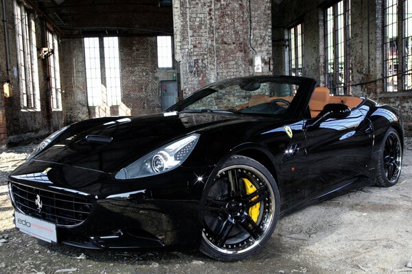 Ferrari de couleur noire avec SOLON brun dans un bâtiment abandonné