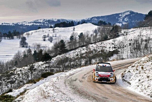 Coche deportivo en una curva cubierta de nieve