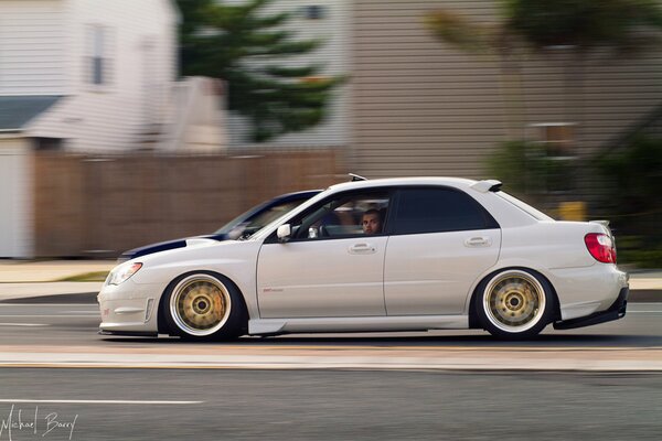 White Subaru Impreza at full speed