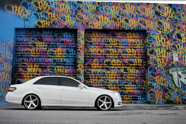 White mercedes side on graffiti background