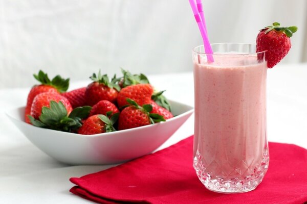 Strawberry cocktail and ripe strawberries in a plate