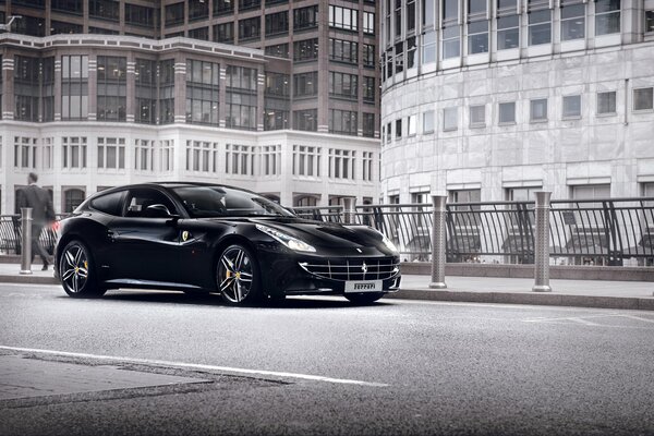 A black Ferrari car on a road background