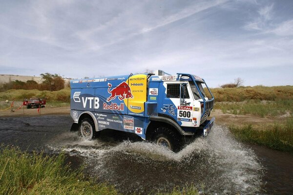 Participant of the KAMAZ Dakar rally crossing the reservoir