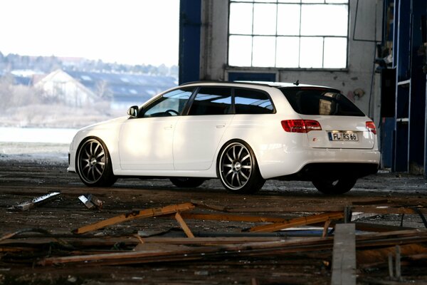 White sports Audi in an unsightly room