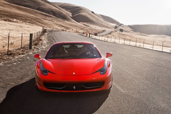 Red Ferrari on the side of the road in the desert