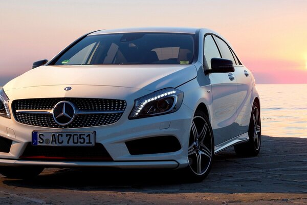 A white Mercedes. Beautiful car at sunset
