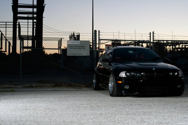 Black tuned BMW at sunset