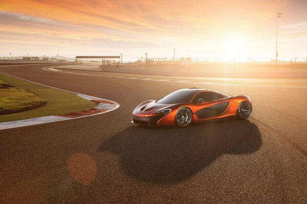 Red supercar on sunset background