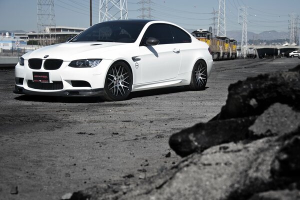 White BMW on the background of a power line