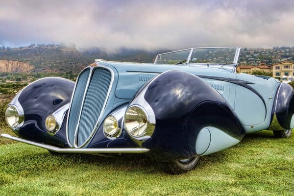 Retro convertible on a gray sky background