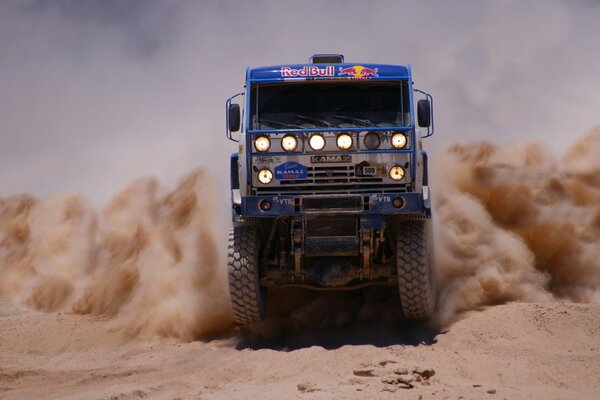 Dust with sand during the movement of KAMAZ