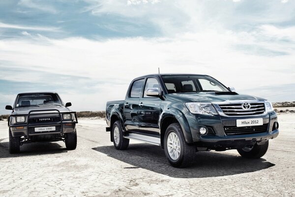 Two Toyotas. Both are pickup trucks.. Different years of release