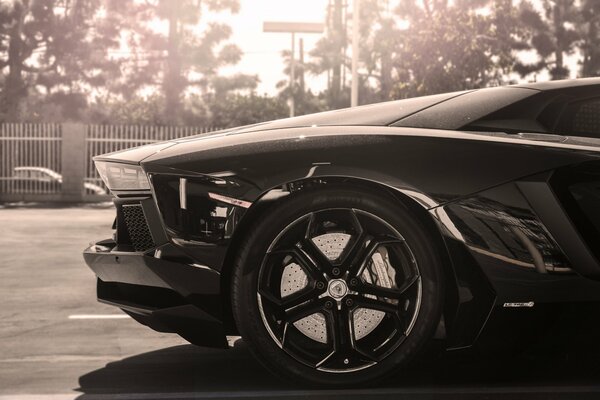 Black lamborghini LP700-4 in the sun with super discs