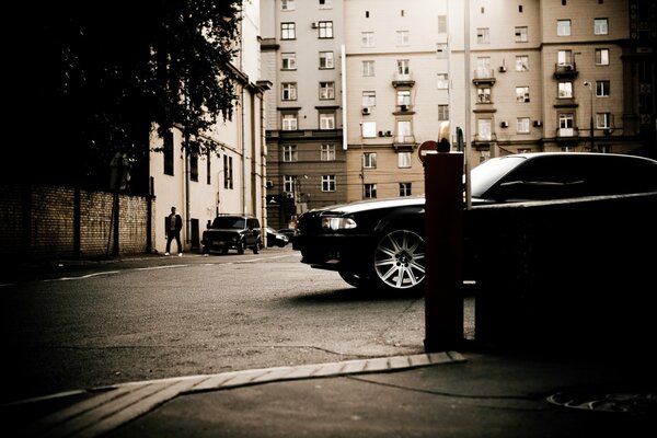 Bmw 750 e38 in the city on the street of the building