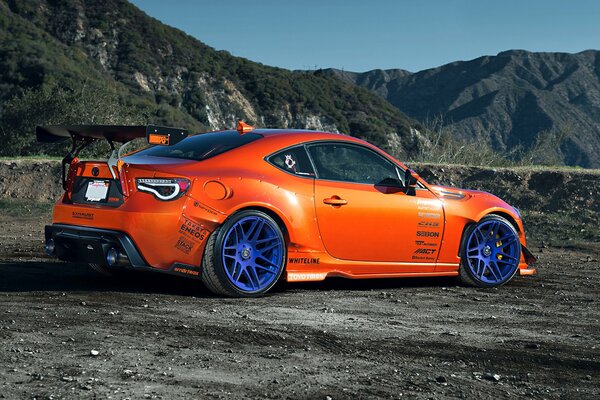 Tuned Toyota with blue wheels