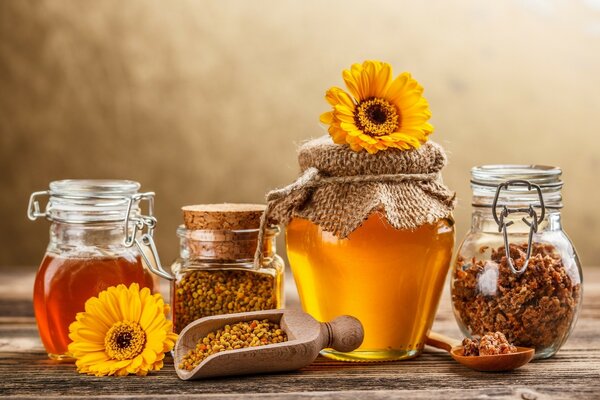 Honey in jars with yellow flowers