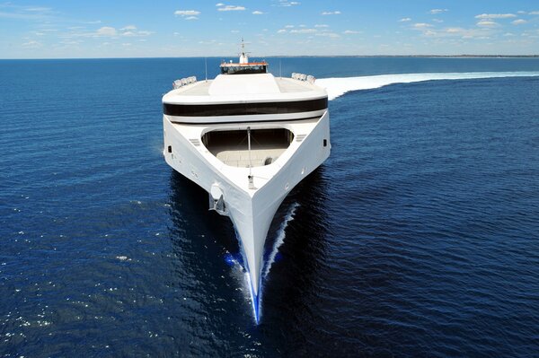 White ship cuts the sea surface