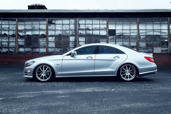 Mercedes Benz silver on the background of an abandoned factory (loft style)