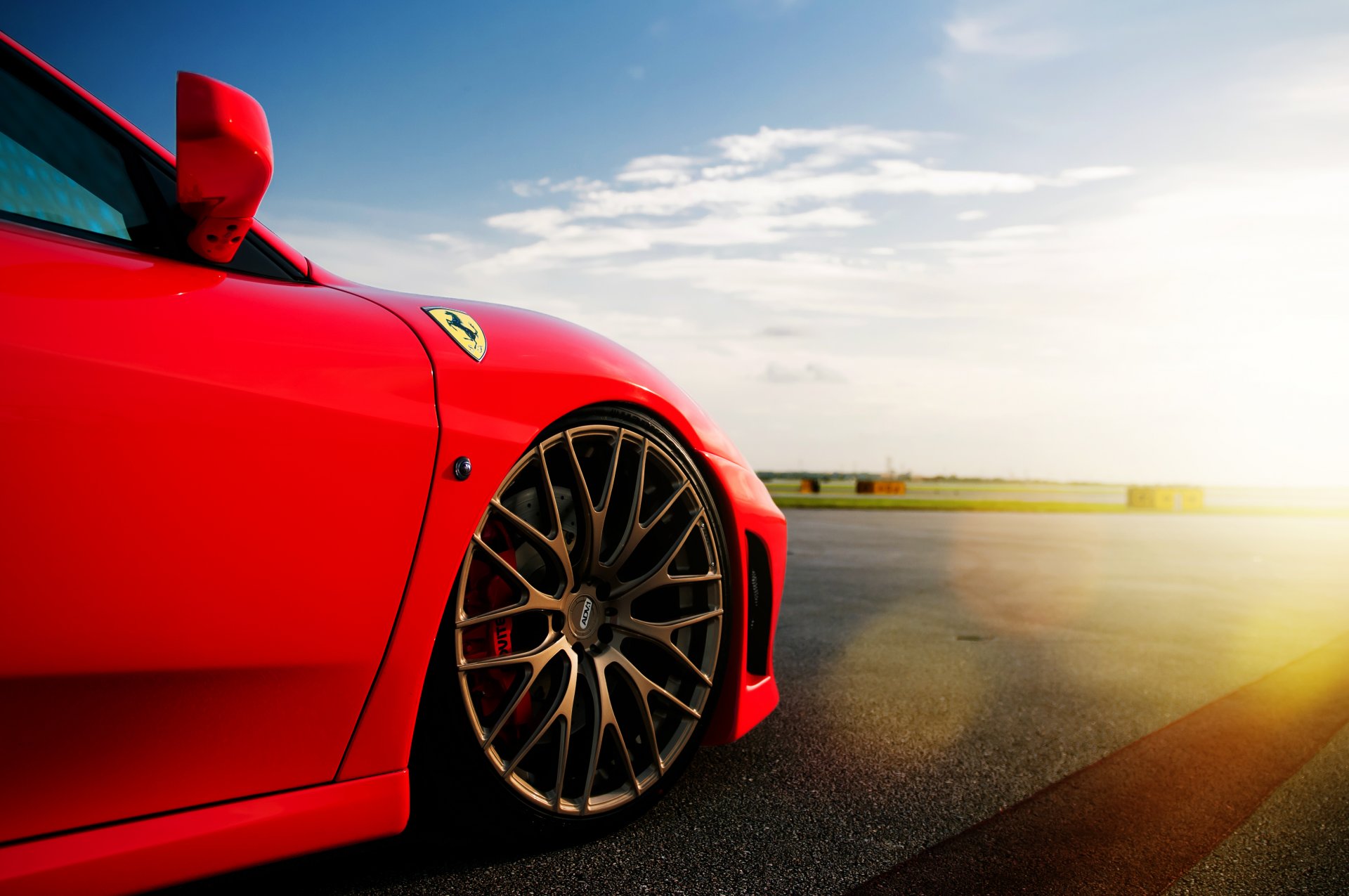 ferrari f-430 red ferrari red tire disc sky clouds sun glare