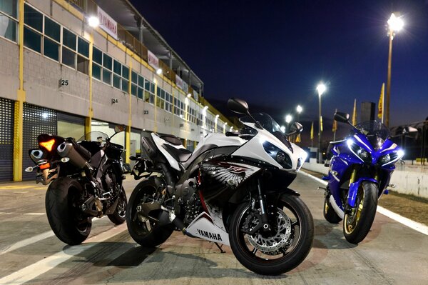 Three motorcycles on the background of the urban landscape