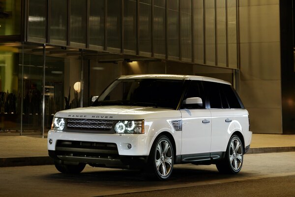 White range rover on the streets of the night city