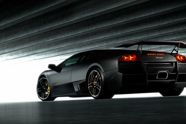 Black matte Lamborghini rear view, low ceiling