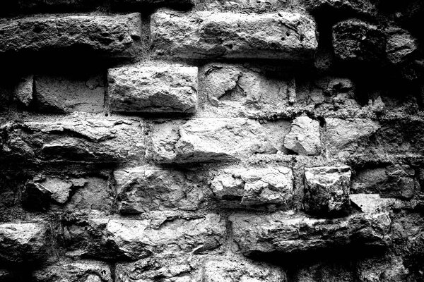 Schwarz-Weiß-Foto einer Ziegelmauer