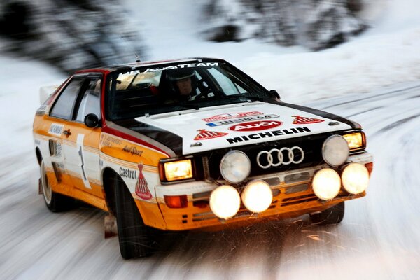 Audi rally rides at high speed in the snow