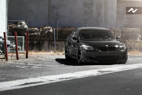 The black BMW turns onto the road