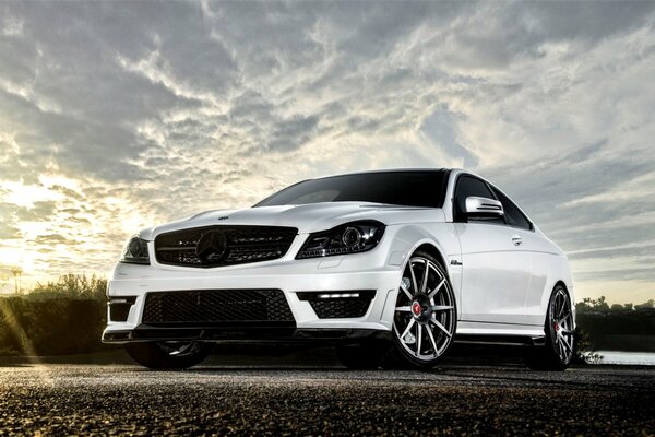 White tuned Mercedes against the sky