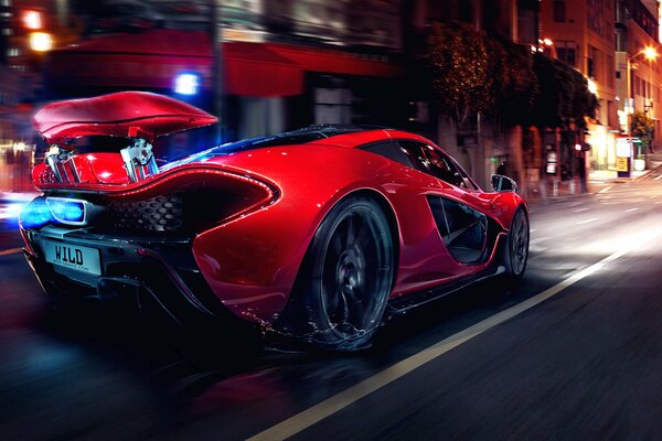 A red supercar is moving down the street at an incredible speed