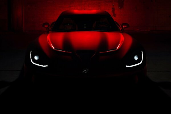 Red Dodge Viper GTS supercar in semi-darkness