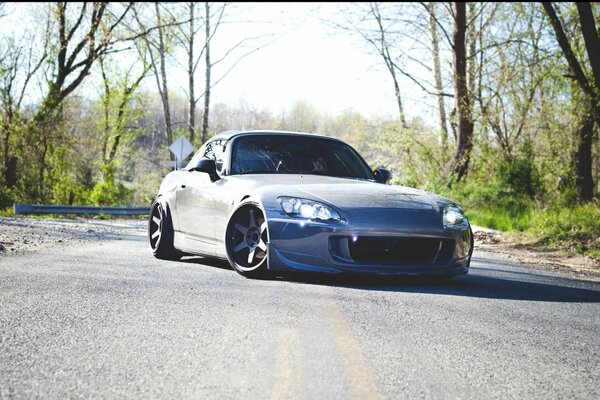 Honda s2000 on the road near the forest