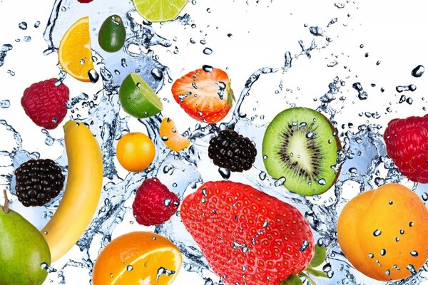 Fruits in splashes of water on a white background
