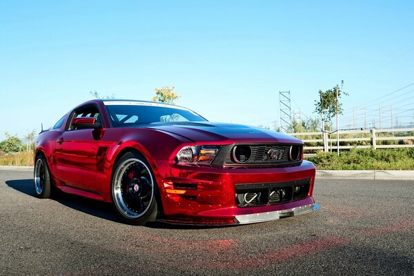 Czerwony Mustang z chromowanymi felgami