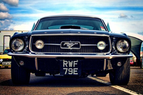 Ford Mustang on the background of blue clouds