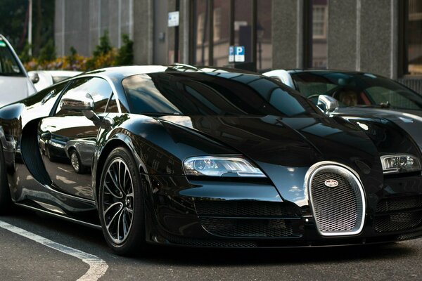 Black tuned sports bugatti on the background of the city